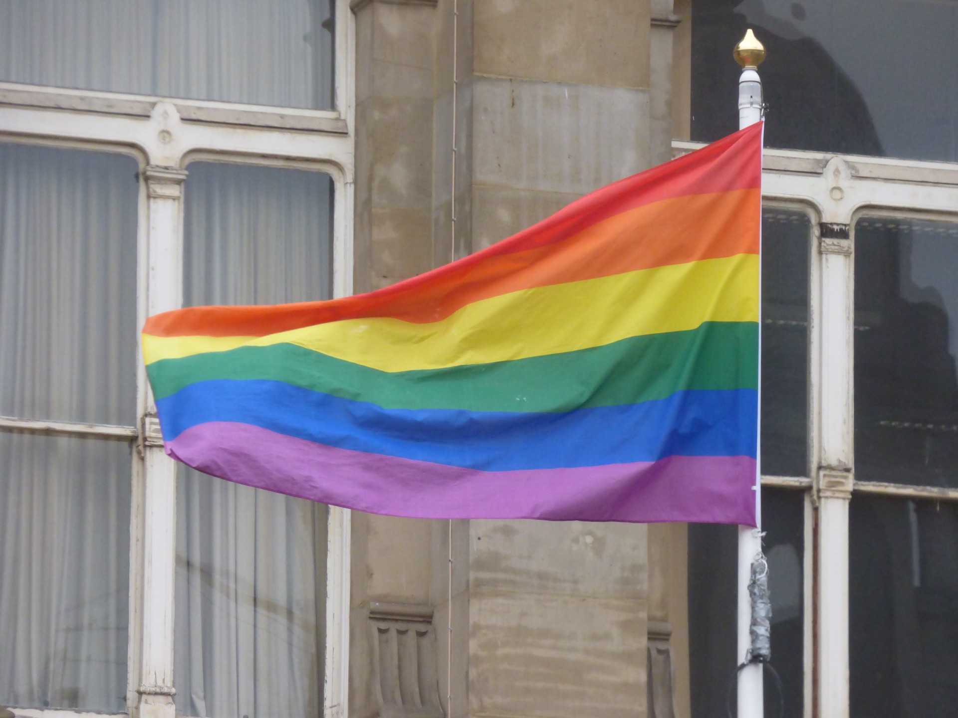 A giant rainbow flag held aloft by the crowd at Birmingham Pride in Victoria Square
